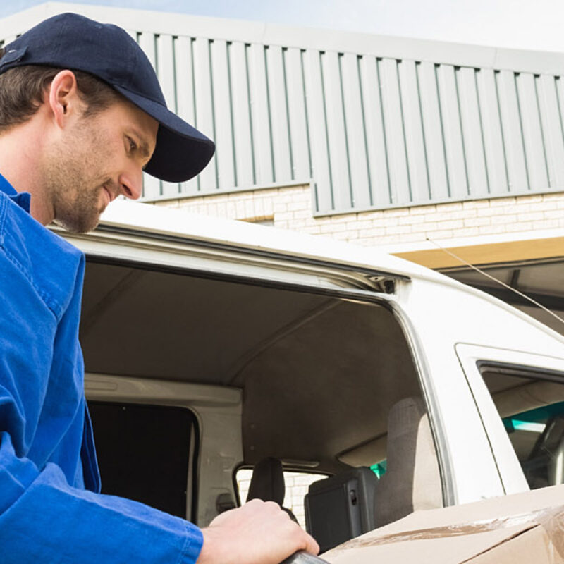 Delivery,Driver,Packing,His,Van,In,A,Large,Warehouse